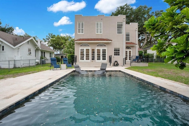 207 W Maxwell St, Lakeland, FL 33803 - back of house featuring french doors, stucco siding, a patio, and a fenced backyard