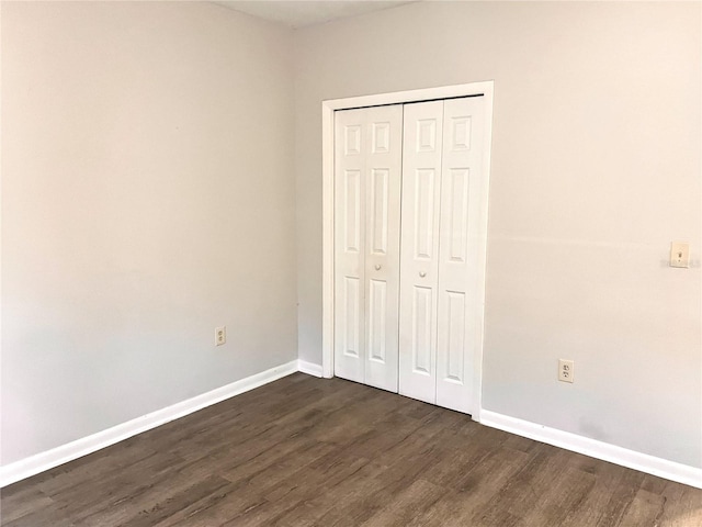 132 Mckean St Unit A, B, Auburndale, FL 33823 - unfurnished bedroom featuring dark wood-style flooring and a closet