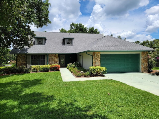1842 Pinnacle Dr, Lakeland, FL 33813 - view of front facade with stone siding, a front lawn, driveway, an attached garage, and roof with shingles