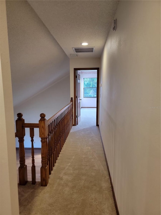 1842 Pinnacle Dr, Lakeland, FL 33813 - hallway featuring light colored carpet and a textured ceiling