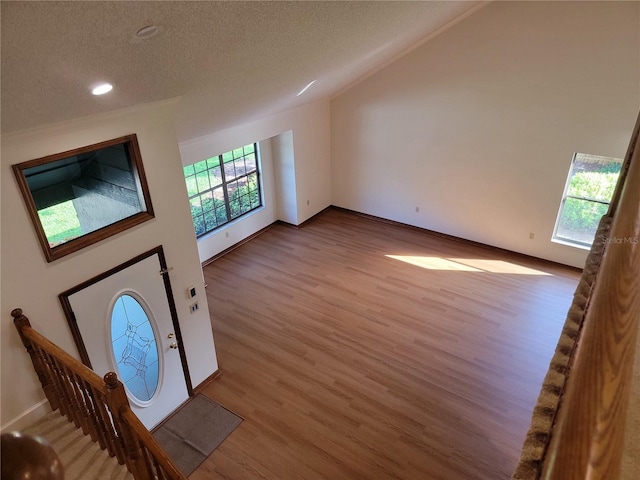 1842 Pinnacle Dr, Lakeland, FL 33813 - foyer entrance featuring wood finished floors, a textured ceiling, stairway, and recessed lighting