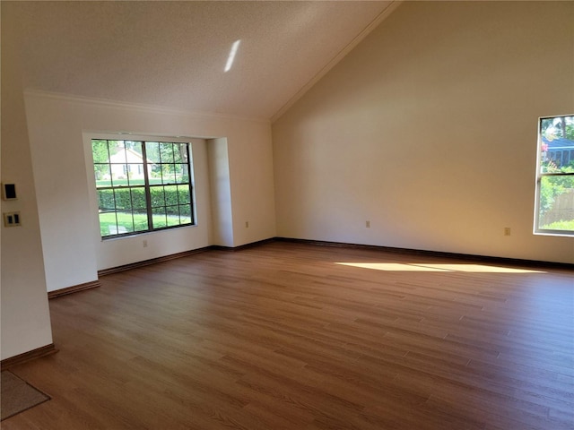1842 Pinnacle Dr, Lakeland, FL 33813 - unfurnished room featuring vaulted ceiling, ornamental molding, wood finished floors, and healthy amount of natural light