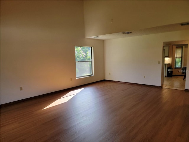 1842 Pinnacle Dr, Lakeland, FL 33813 - empty room featuring wood finished floors and a towering ceiling