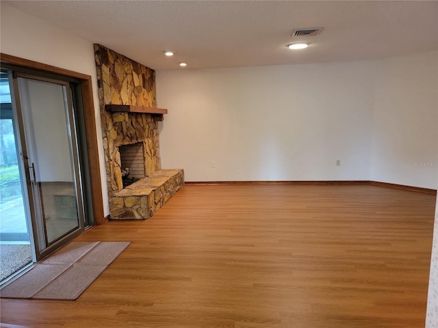 1842 Pinnacle Dr, Lakeland, FL 33813 - unfurnished living room featuring light wood-style floors, a fireplace, and recessed lighting