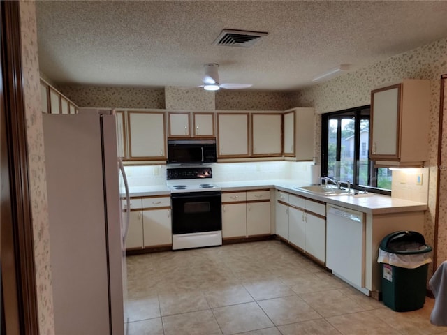 1842 Pinnacle Dr, Lakeland, FL 33813 - kitchen with white appliances, wallpapered walls, light countertops, a textured ceiling, and a ceiling fan
