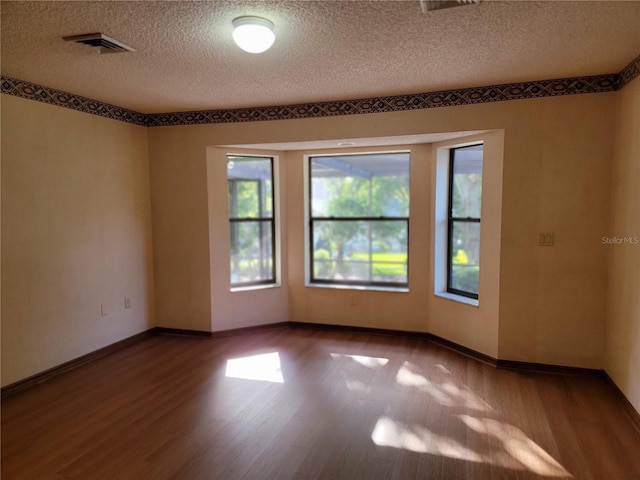 1842 Pinnacle Dr, Lakeland, FL 33813 - empty room with a textured ceiling and wood finished floors