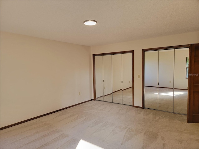 1842 Pinnacle Dr, Lakeland, FL 33813 - unfurnished bedroom with carpet and two closets