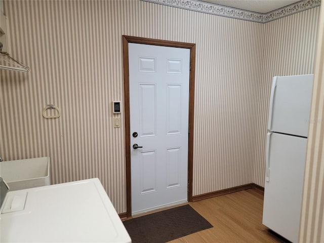 1842 Pinnacle Dr, Lakeland, FL 33813 - laundry room with wood finished floors and wallpapered walls