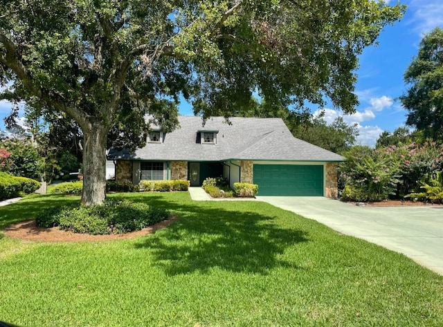 1842 Pinnacle Dr, Lakeland, FL 33813 - view of front of property featuring stone siding, an attached garage, driveway, and a front yard