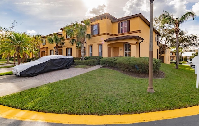 243 Palermo St, Davenport, FL 33897 - view of front of house with a front yard and stucco siding