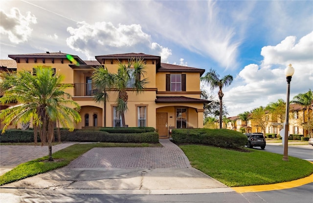 243 Palermo St, Davenport, FL 33897 - mediterranean / spanish house with stucco siding, a front lawn, and a balcony