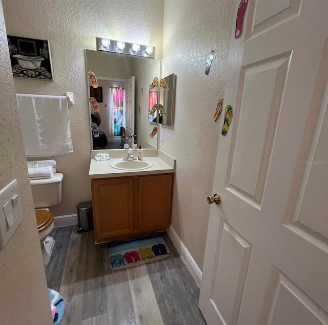 243 Palermo St, Davenport, FL 33897 - half bath with vanity, wood finished floors, and a textured wall