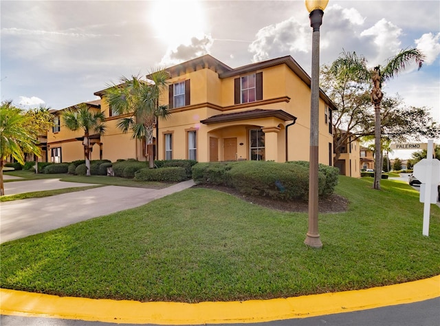 243 Palermo St, Davenport, FL 33897 - mediterranean / spanish house featuring a front lawn and stucco siding