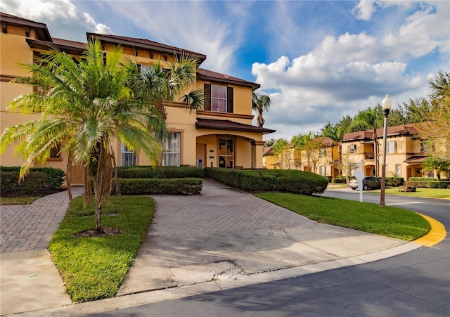 243 Palermo St, Davenport, FL 33897 - mediterranean / spanish-style home with stucco siding and a residential view