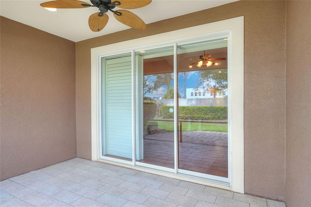 2929 Mission Lakes Dr Unit 10, Lakeland, FL 33803 - doorway to property with ceiling fan, a patio area, and stucco siding