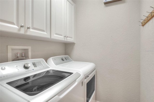 2929 Mission Lakes Dr Unit 10, Lakeland, FL 33803 - washroom featuring independent washer and dryer, cabinet space, and a textured wall