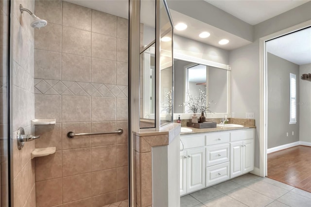 2929 Mission Lakes Dr Unit 10, Lakeland, FL 33803 - full bath featuring double vanity, a stall shower, tile patterned flooring, and recessed lighting