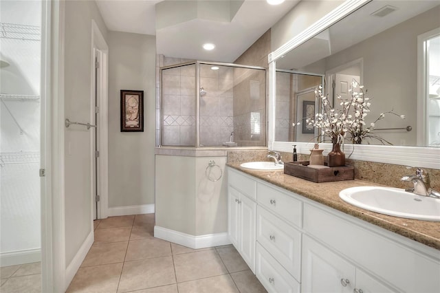 2929 Mission Lakes Dr Unit 10, Lakeland, FL 33803 - bathroom with a shower stall, double vanity, tile patterned flooring, and a walk in closet