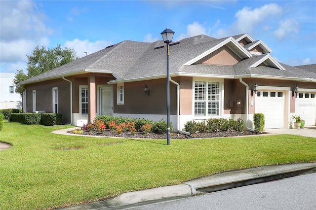 2929 Mission Lakes Dr Unit 10, Lakeland, FL 33803 - view of front facade featuring a garage, a front yard, stucco siding, and driveway