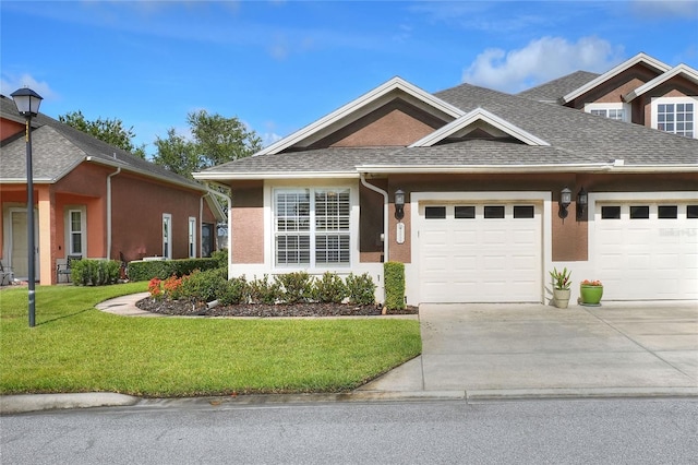 2929 Mission Lakes Dr Unit 10, Lakeland, FL 33803 - view of front of property featuring concrete driveway, a garage, a front lawn, and a shingled roof