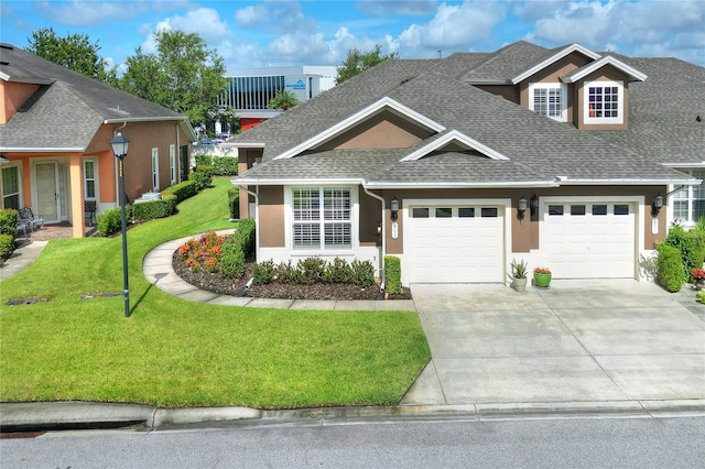 2929 Mission Lakes Dr Unit 10, Lakeland, FL 33803 - view of front of home featuring a shingled roof, an attached garage, concrete driveway, and stucco siding