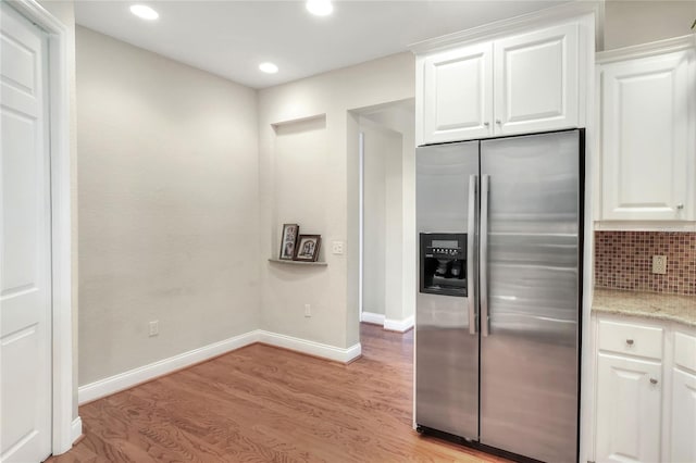 2929 Mission Lakes Dr Unit 10, Lakeland, FL 33803 - kitchen featuring stainless steel refrigerator with ice dispenser, light wood-type flooring, recessed lighting, light stone countertops, and white cabinetry
