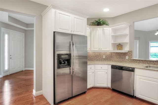 2929 Mission Lakes Dr Unit 10, Lakeland, FL 33803 - kitchen with appliances with stainless steel finishes, open shelves, tasteful backsplash, light wood finished floors, and recessed lighting
