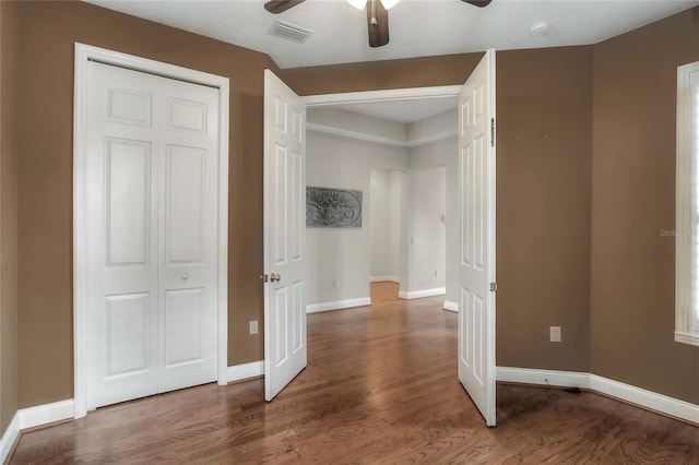 2929 Mission Lakes Dr Unit 10, Lakeland, FL 33803 - unfurnished bedroom with wood finished floors, ceiling fan, and a closet