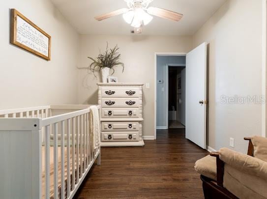 1420 S Lincoln Ave, Lakeland, FL 33803 - bedroom with dark wood-style floors, a crib, and ceiling fan