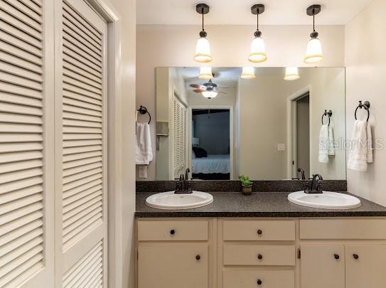 1420 S Lincoln Ave, Lakeland, FL 33803 - ensuite bathroom featuring a closet, double vanity, and ceiling fan