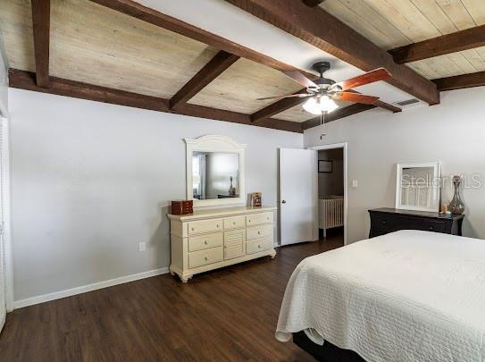 1420 S Lincoln Ave, Lakeland, FL 33803 - bedroom with radiator heating unit, dark wood finished floors, ceiling fan, and a wooden ceiling with exposed beams
