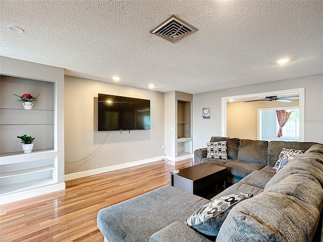 310 Keystone Rd, Auburndale, FL 33823 - living area featuring built in features, wood finished floors, a textured ceiling, recessed lighting, and ceiling fan