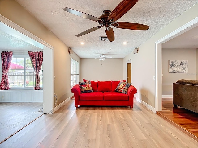 310 Keystone Rd, Auburndale, FL 33823 - living room featuring a textured ceiling, light wood-style flooring, and ceiling fan