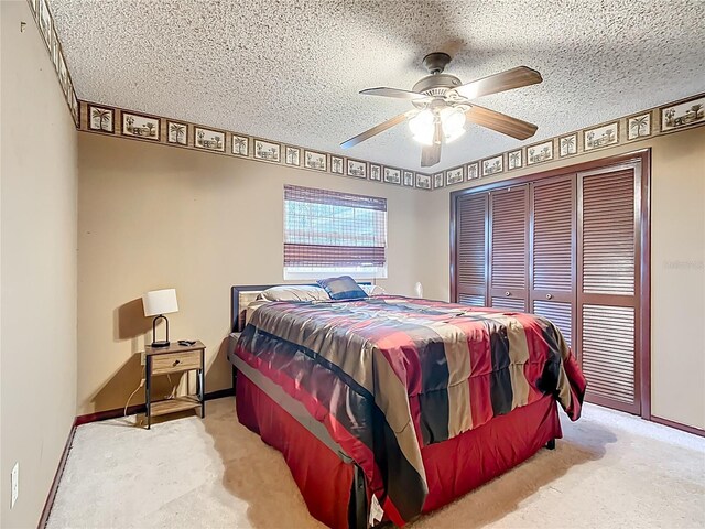 310 Keystone Rd, Auburndale, FL 33823 - bedroom featuring carpet flooring, a closet, a ceiling fan, and a textured ceiling