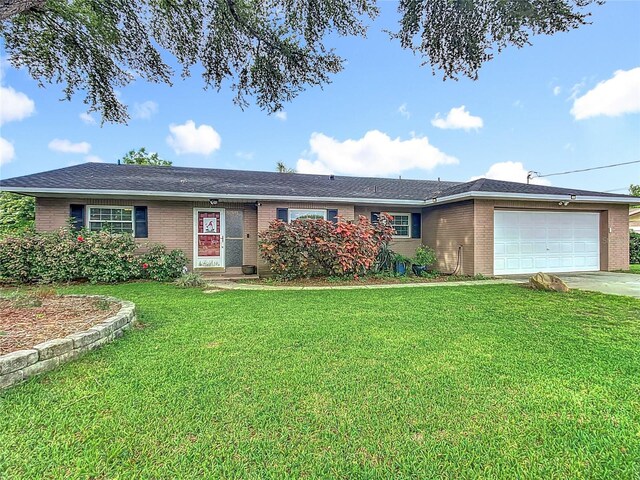 310 Keystone Rd, Auburndale, FL 33823 - single story home with brick siding, an attached garage, and a front yard