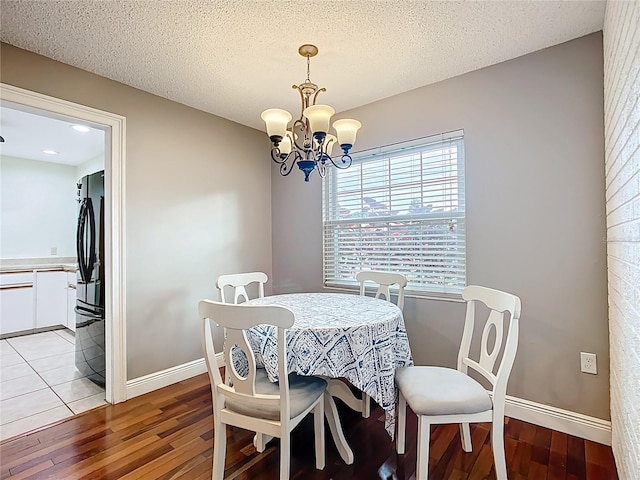 310 Keystone Rd, Auburndale, FL 33823 - dining space with light wood-style floors and a chandelier