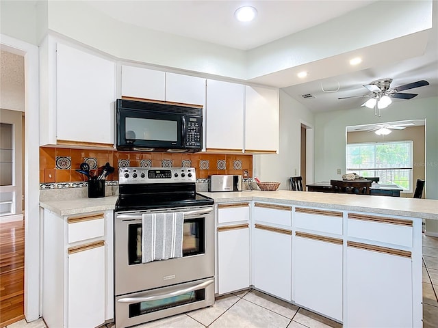 310 Keystone Rd, Auburndale, FL 33823 - kitchen featuring black microwave, stainless steel electric range, a peninsula, light countertops, and white cabinetry