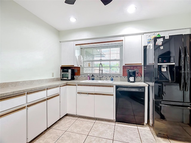 310 Keystone Rd, Auburndale, FL 33823 - kitchen with black appliances, white cabinetry, light tile patterned flooring, light countertops, and tasteful backsplash