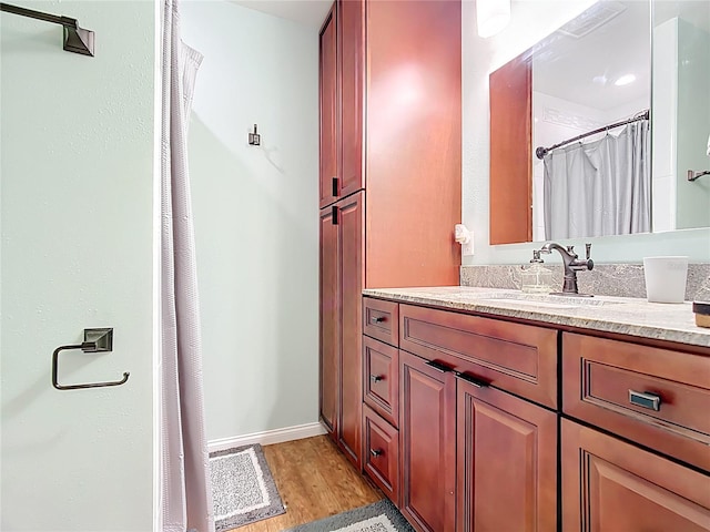 310 Keystone Rd, Auburndale, FL 33823 - bathroom with wood finished floors, vanity, and a shower with curtain