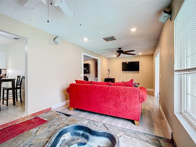 310 Keystone Rd, Auburndale, FL 33823 - living room with ceiling fan, a textured ceiling, healthy amount of natural light, wood finished floors, and recessed lighting