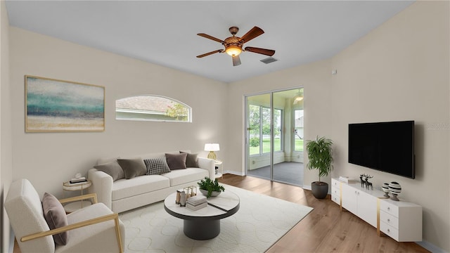 4445 Pebble Pointe Dr, Lakeland, FL 33813 - living area with healthy amount of natural light, a ceiling fan, and wood finished floors