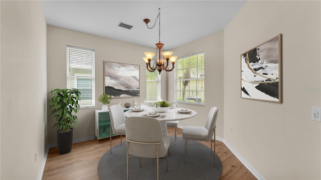 4445 Pebble Pointe Dr, Lakeland, FL 33813 - dining space featuring a chandelier, plenty of natural light, and light wood-style flooring