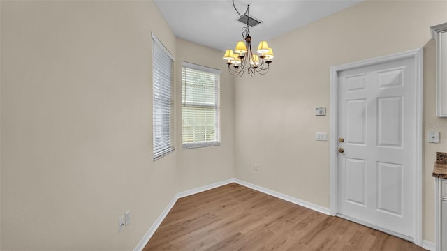 4445 Pebble Pointe Dr, Lakeland, FL 33813 - unfurnished dining area with a chandelier and light wood finished floors