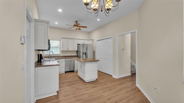 4445 Pebble Pointe Dr, Lakeland, FL 33813 - kitchen featuring appliances with stainless steel finishes, a kitchen island, light wood-style flooring, ceiling fan, and recessed lighting