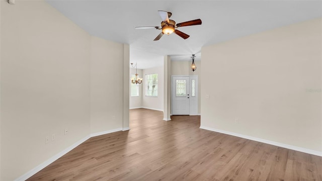 4445 Pebble Pointe Dr, Lakeland, FL 33813 - unfurnished room with a chandelier, wood finished floors, and ceiling fan