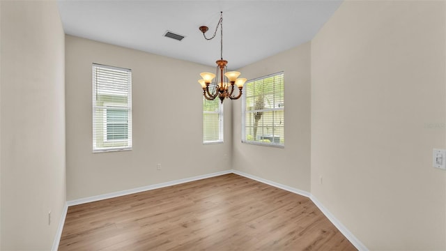 4445 Pebble Pointe Dr, Lakeland, FL 33813 - spare room with a chandelier and light wood-type flooring