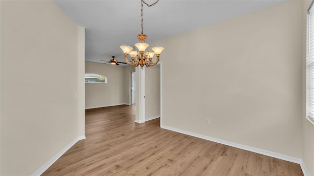 4445 Pebble Pointe Dr, Lakeland, FL 33813 - empty room featuring a chandelier, light wood finished floors, and a ceiling fan