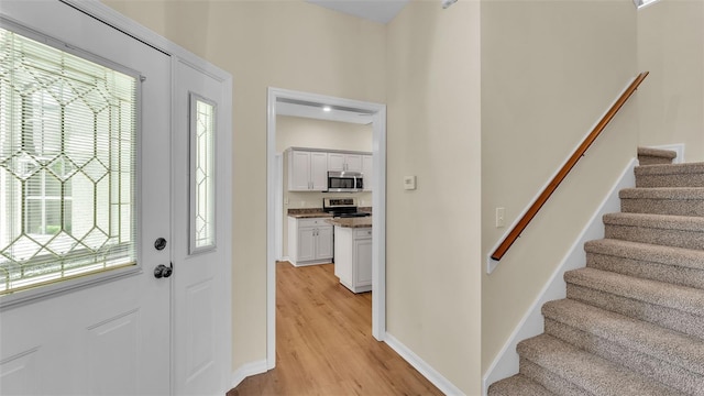 4445 Pebble Pointe Dr, Lakeland, FL 33813 - foyer with light wood-style floors and stairs