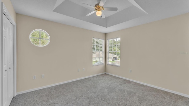 4445 Pebble Pointe Dr, Lakeland, FL 33813 - carpeted spare room with plenty of natural light, a tray ceiling, and a ceiling fan