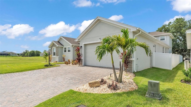 1095 Woodland Oaks Dr, Lakeland, FL 33813 - ranch-style home with decorative driveway, an attached garage, and stucco siding